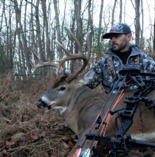 Bowhunter posing behind his big buck harvested in Pike County, IL